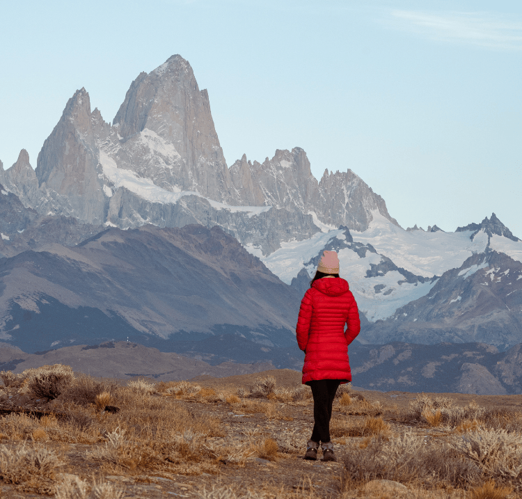 a lady hiking in front of Argentina mountains