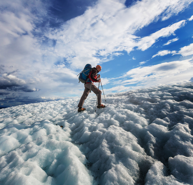 a man trekking on top of glacier ice