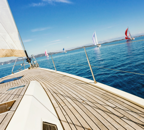 group of people sailing their boats in the wide open ocean