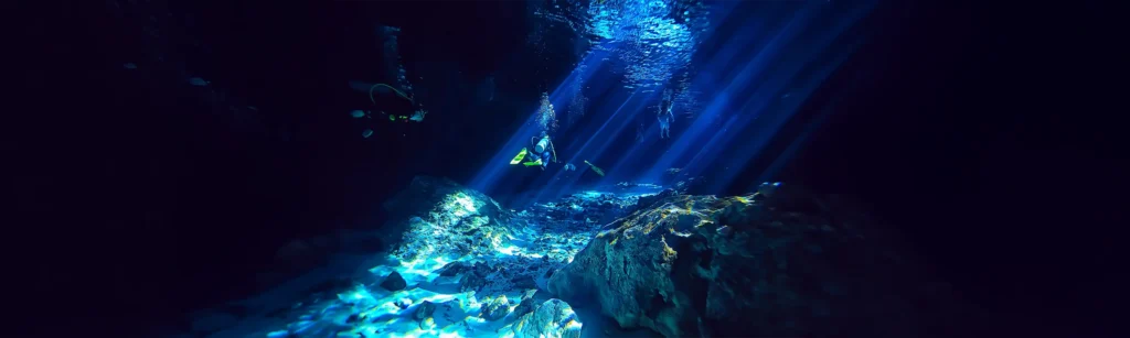 divers inside a cave pool